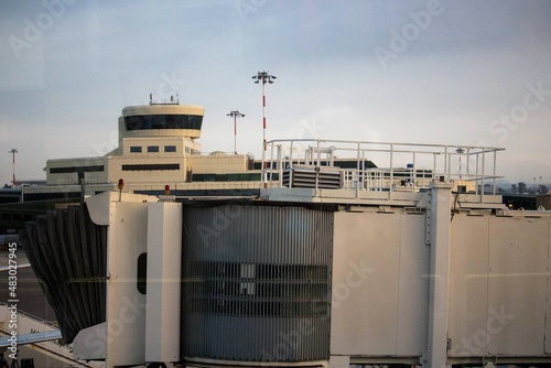 evocative image of the final part of the boarding sleeve or telescopic gangway (boarding pier) of an airport seen from the windows on a bad day 