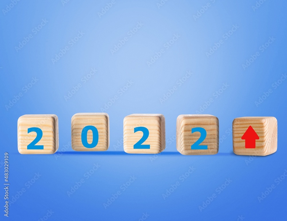 Obraz premium Wooden blocks with new year 2022, arrow up icons, Business development and growth concept