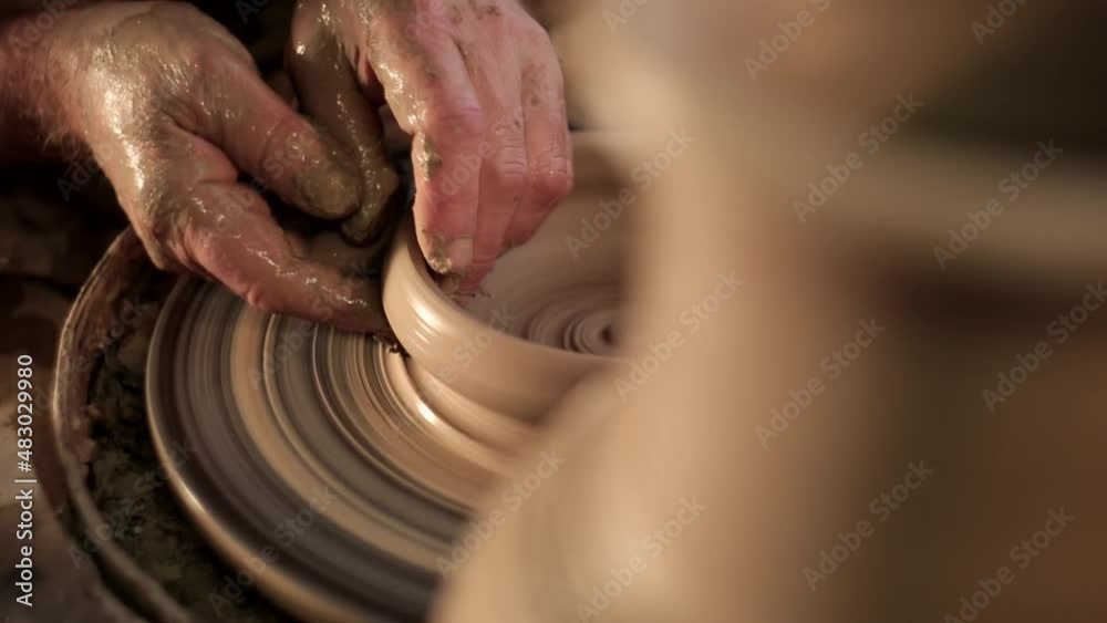 Potter making jug. Close-up of potter making ceramic jug on at his workshop