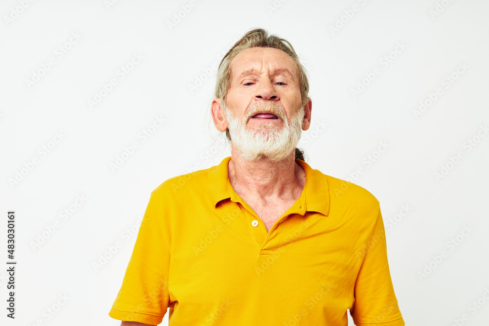 Obraz premium Photo of retired old man with a gray beard emotion gestures hands light background