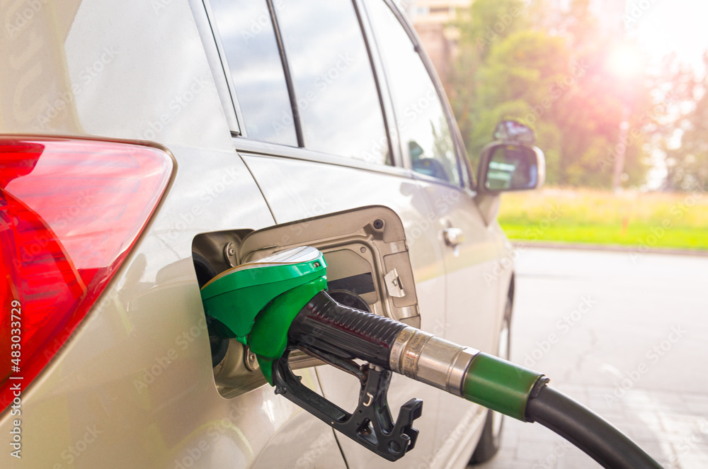 Fototapeta premium Refueling the car with diesel at a gas station. Car refueling on petrol station. Fuel pump at station. Selective focus