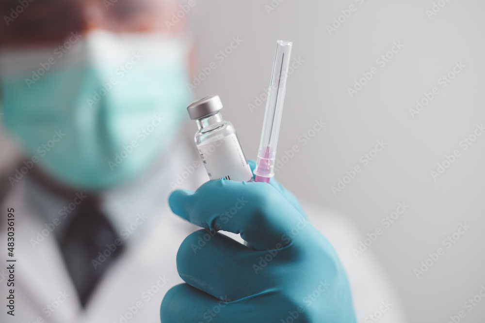doctor or scientist in the COVID-19 medical vaccine research and development laboratory holds a syringe with a liquid vaccine to study and analyze antibody samples for the patient.
doctor or scientist in the COVID-19 medical vaccine research and development laboratory holds a syringe with a liquid vaccine to study and analyze antibody samples for the patient.