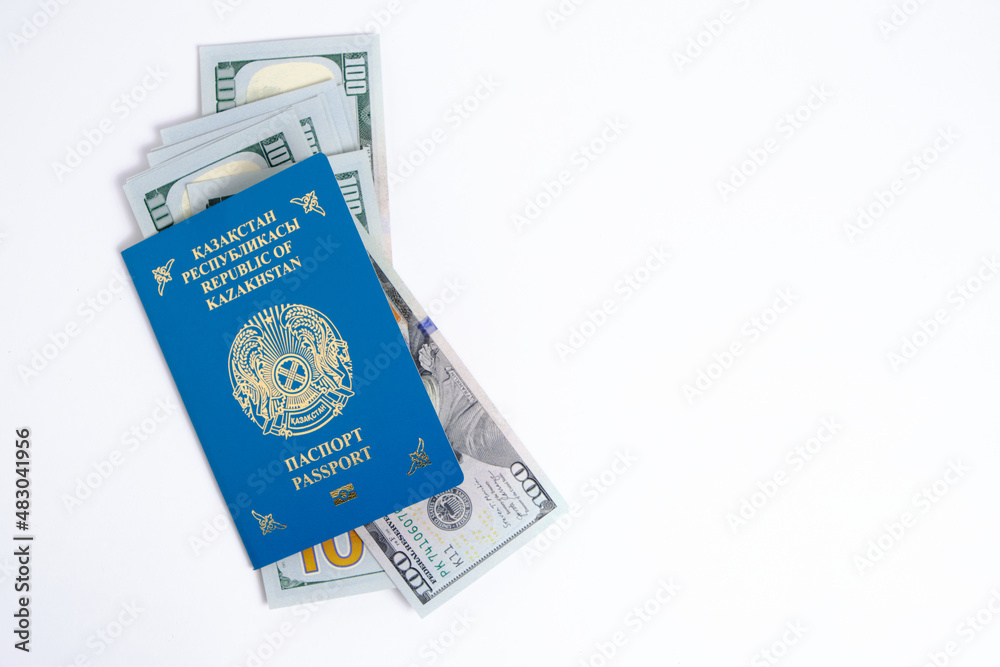 Passport citizen Republic Kazakhstan blue with coat arms and pack hundred-dollar bills inside, on white background. Passport citizen Republic Kazakhstan blue with coat arms and pack hundred-dollar bills inside, on white background.