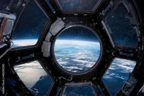 Earth planet in the ISS porthole. View from Cupole. International space station. Surface and horizon. Elements of this image furnished by NASA photo