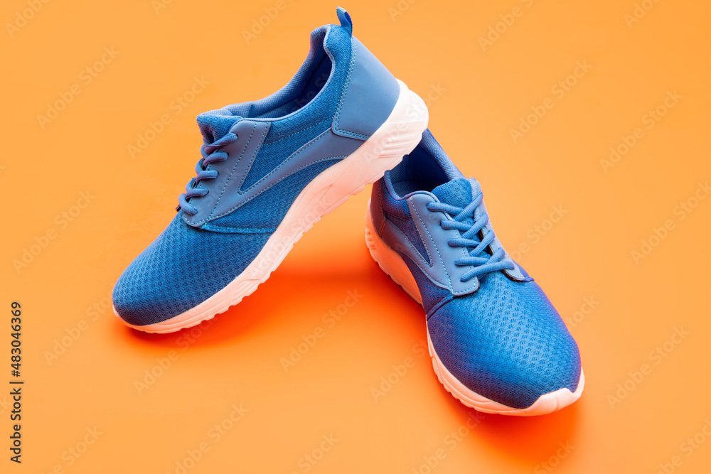 pair of footwear for training on orange background, sport pair of footwear for training on orange background, sport