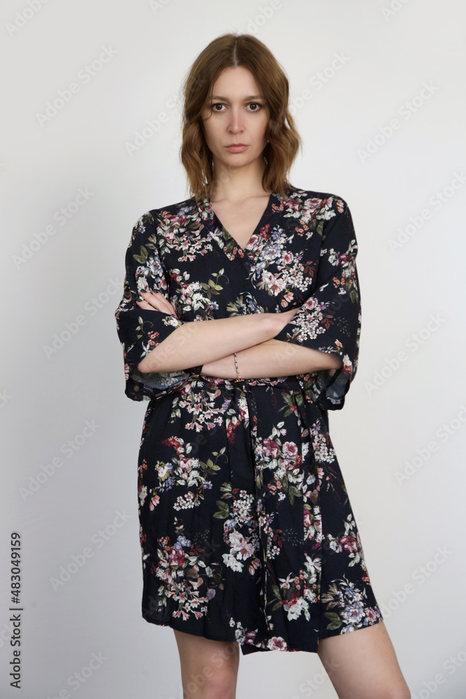 Woman in dark floral robe dress, studio shot. Woman in dark floral robe dress, studio shot.