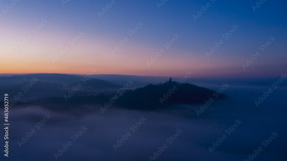 morning mood at the blue hour drone panorama with castle and morning fog