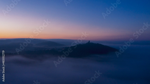 morning mood at the blue hour drone panorama with castle and morning fog