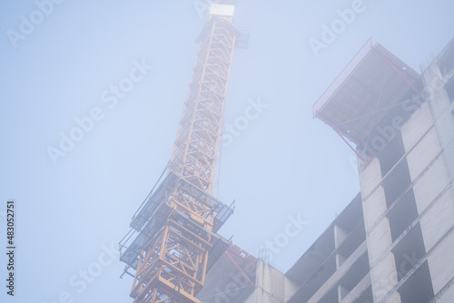 Multi-storey house construction process on a foggy autumn morning. Construction process concept