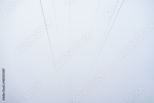 Power line disappearing in the fog