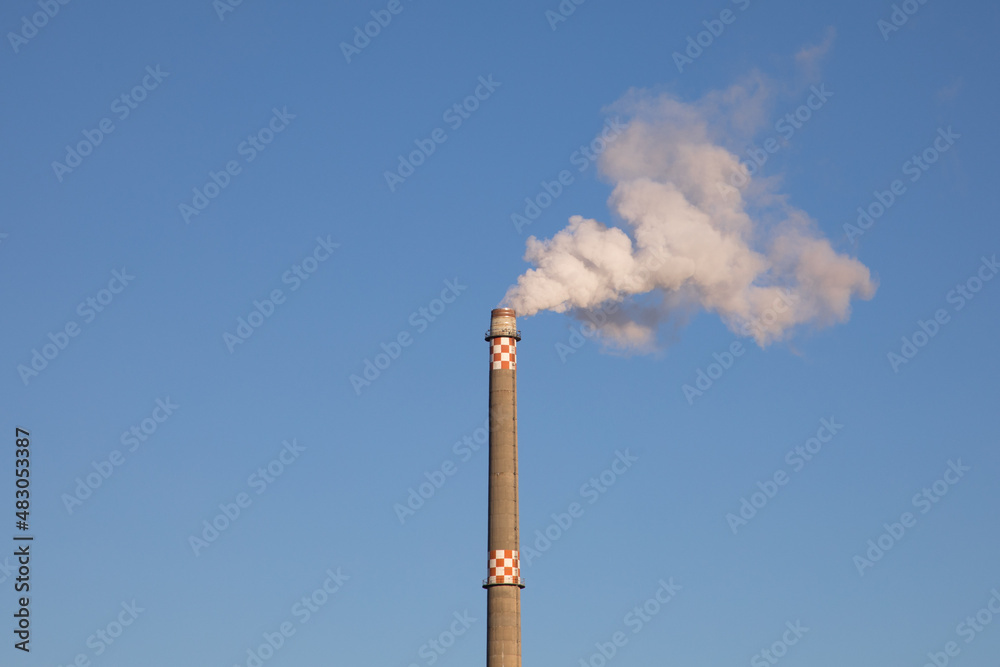 Chimney, High Factory Chimney with white Smoke isolated on Blue sky