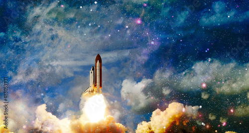 Fototapeta Naklejka Na Ścianę i Meble -  Spaceship flight.Space shuttle launch in the clouds to outer space. Dark space with stars on background.  Elements of this image furnished by NASA