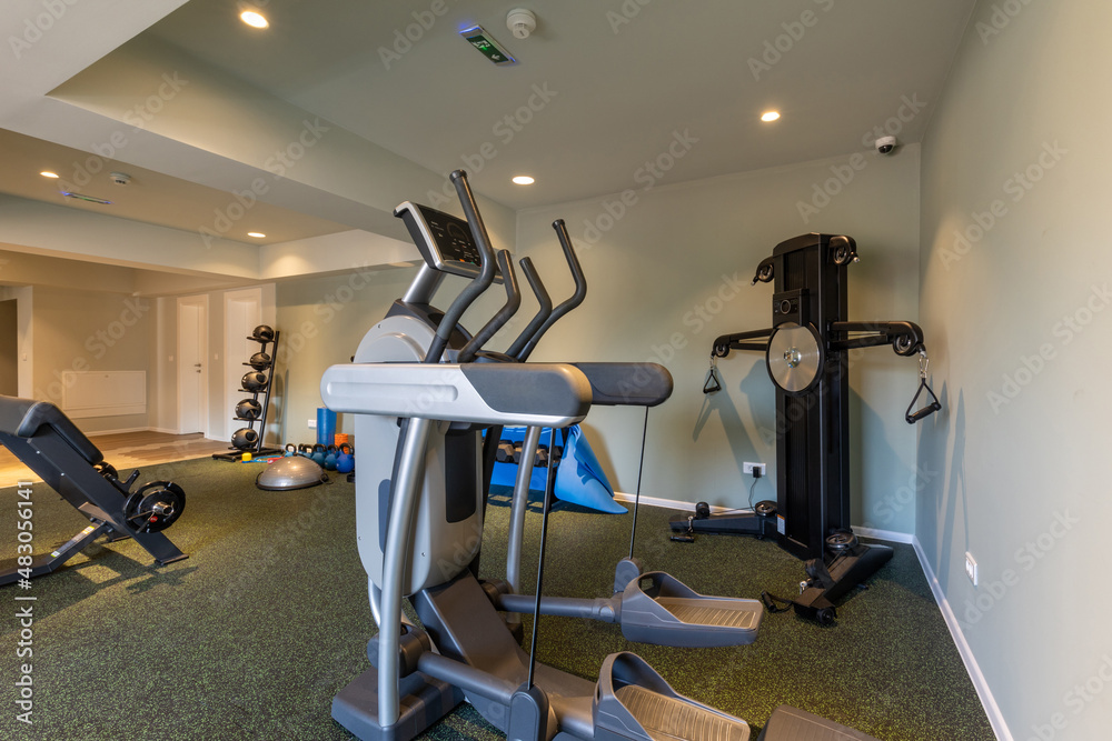 Interior of an empty hotel gym with equipment Interior of an empty hotel gym with equipment