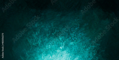 The scuffed blue texture of a cement or concrete wall with a light spot . Dark abstract background with cracks and scuffs