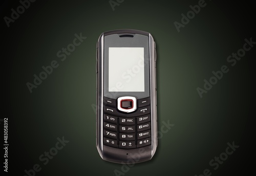 Old retro mobile phone on dark background