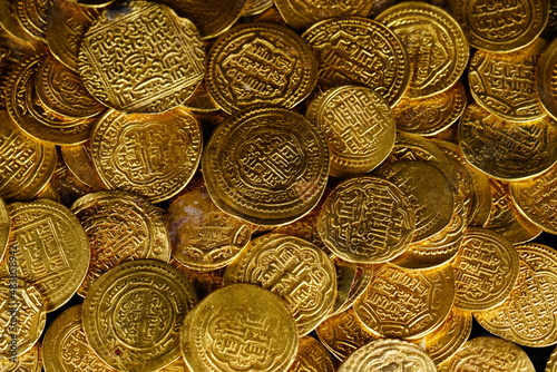 A pile of golden coins , saving money, business and financial concept. selective focus. Gold treasure. Ancient  coin. Golden money. rich government money. 