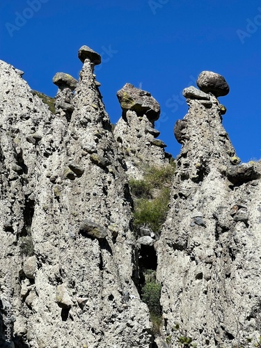 Stone mushrooms in the Akkurum tract against blue sky, the rock formations of a bizarre shape, Altai, Russia photo