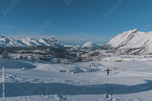 An unrecognizable male hiker wearing snowshoes walking in the French Alps on a cold winter day (L'Enclus, Devoluy, Hautes-Alpes)
