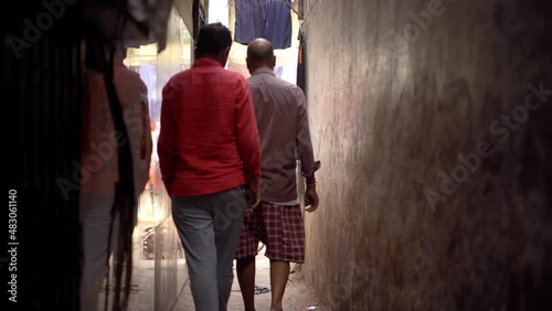 poor peope of dharavi walking from narrow lane to market photo