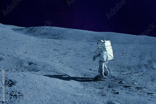Fototapeta Naklejka Na Ścianę i Meble -  Astronaut on the moon, with galactic background. Elements of this image were furnished by NASA.