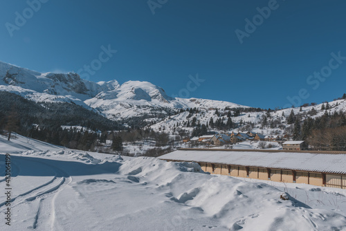 A picturesque view of a remote building in the snowcapped French Alps mountains on a cold winter day (L'Enclus, Devoluy)