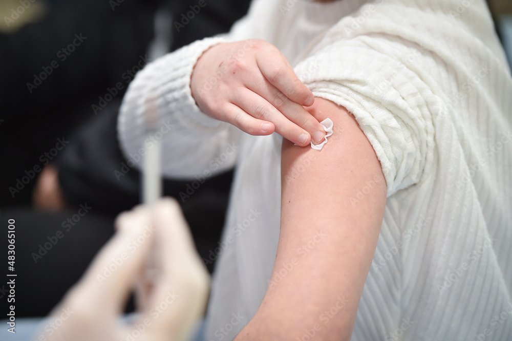 BUCHAREST, ROMANIA - JANUARY 26, 2022: A child is about to get a dose of COVID19 vaccine inside a vaccination center in Bucharest.