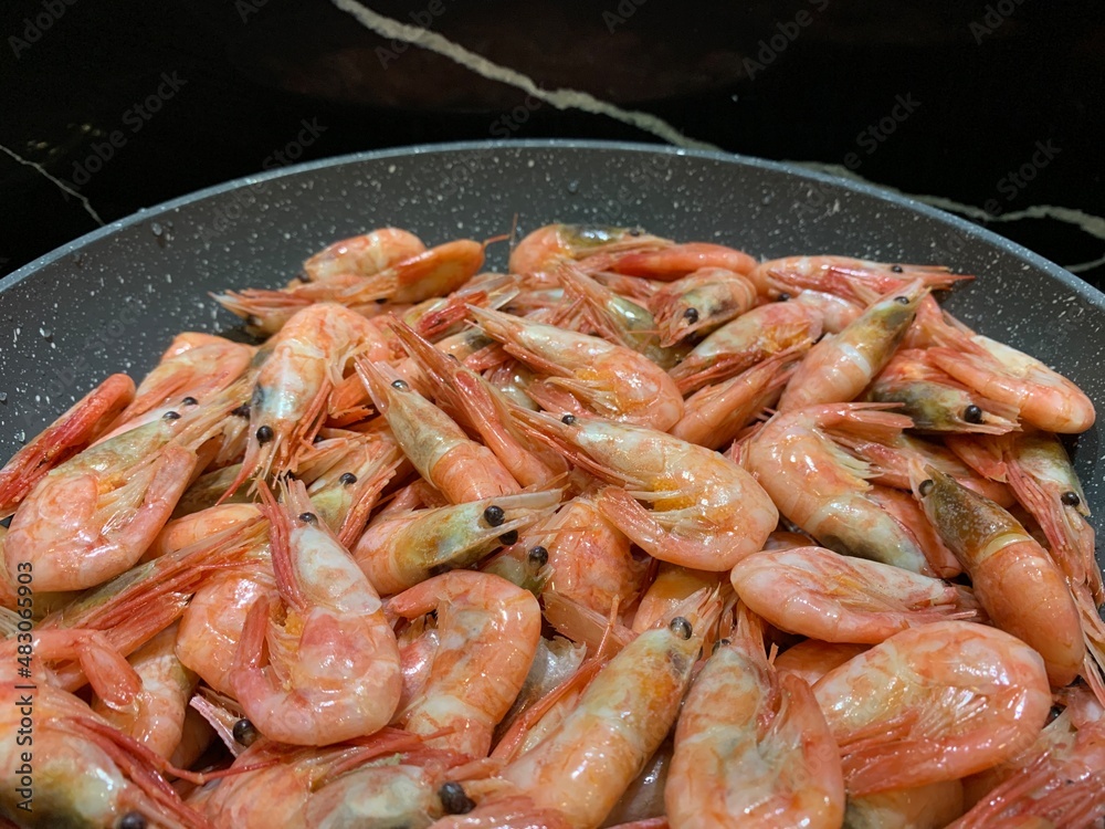 Shrimps cooked in sauce. Cooking seafood with spices, close-up. A dish with shrimps in a frying pan. Shrimps cooked in sauce. Cooking seafood with spices, close-up. A dish with shrimps in a frying pan.