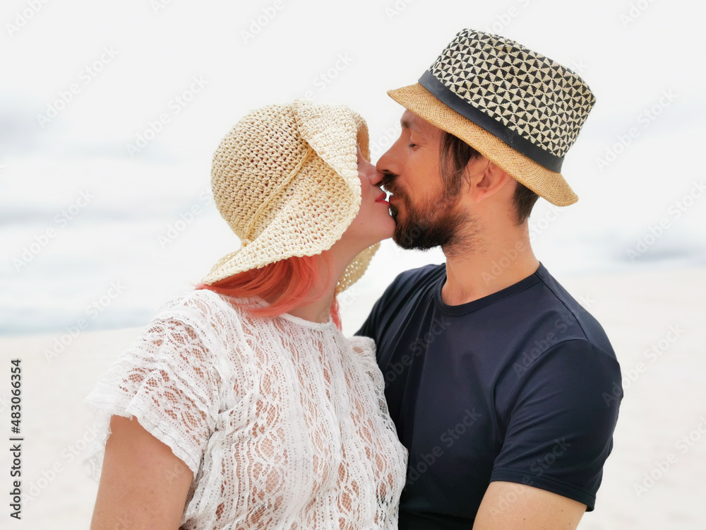 Adult couple in love Close-up of smiling people. Beautiful young international family hugging on the beach. Girl with pink hair. Honeymoon trip, 14 February. Love, hugs, tenderness, trust