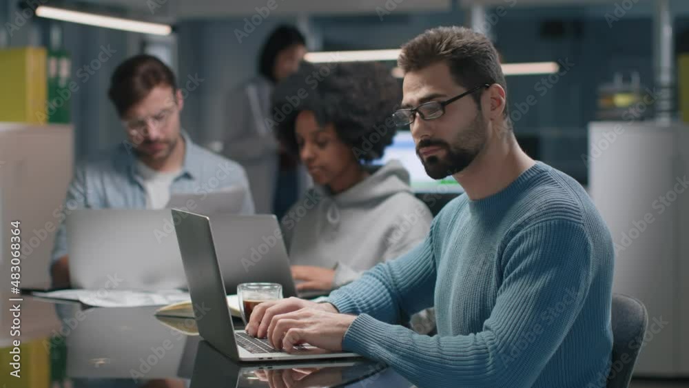 Successful entrepreneur smiling at camera working in modern startup company Successful entrepreneur smiling at camera working in modern startup company
