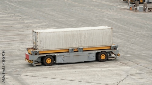 Remotely operated driverless container truck in the port. A remotely operated vehicle using the magnet field on the terminal. photo