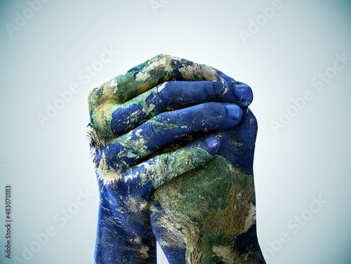 We are the world. A cropped shot of hands painted to look like the earth. photo