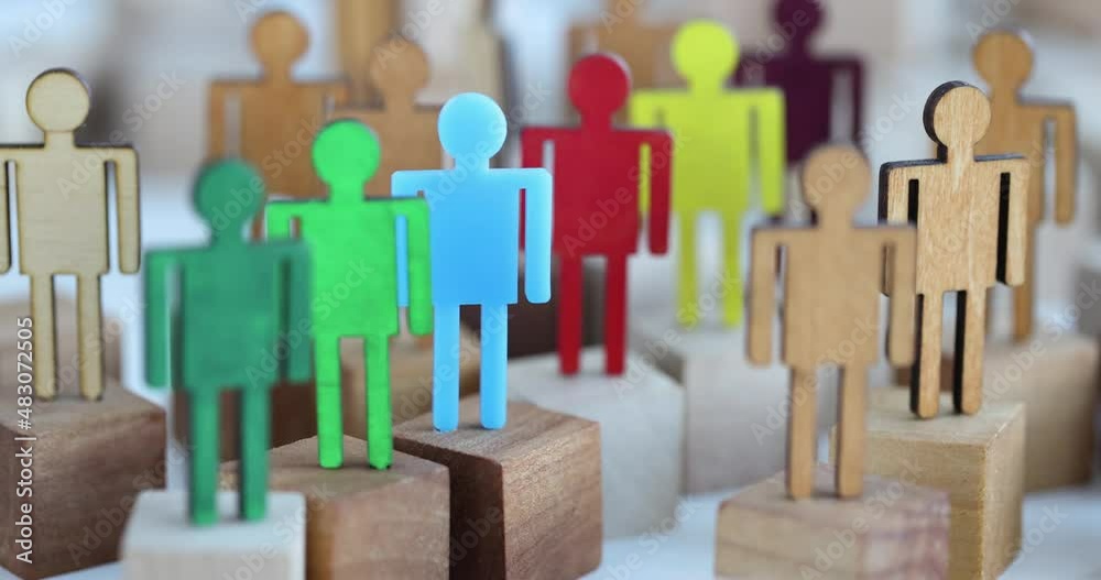 Multi-colored wooden figurines in crowd closeup Multi-colored wooden figurines in crowd closeup