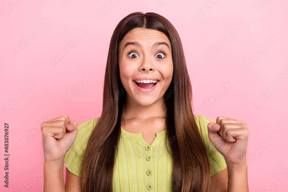 Photo of astonished lady raise fists celebrate victory crazy rejoice wear green top isolated pink color background Photo of astonished lady raise fists celebrate victory crazy rejoice wear green top isolated pink color background