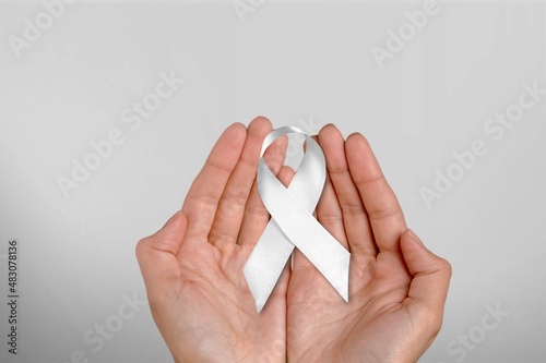 White January, mental health awareness campaign. hand hold a white ribbon. photo