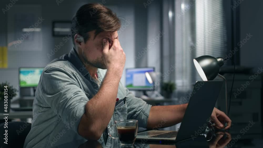 Side view of exhausted caucasian businesswoman working late in office Side view of exhausted caucasian businesswoman working late in office