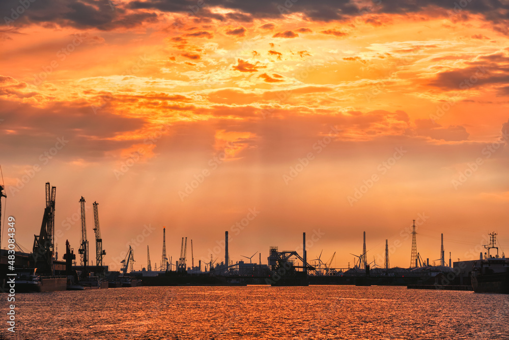 Port of Antwerp crane silhouettes on sunset. Antwerp, Belgium