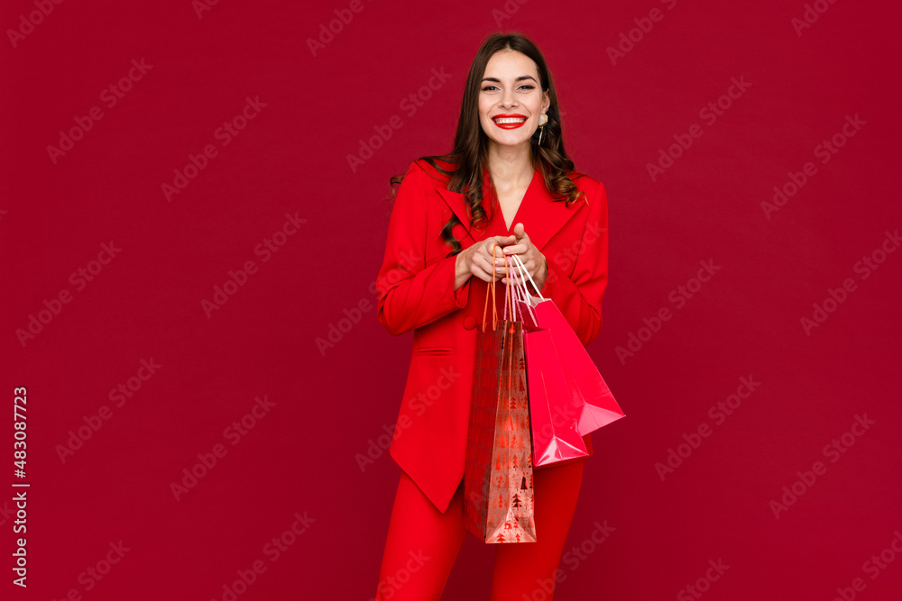 attractive woman in red with shopping bags sale on red background Saint Valentine's Day attractive woman in red with shopping bags sale on red background Saint Valentine's Day