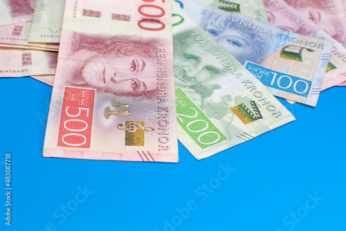 Swedish krona banknotes of different denominations on a blue background