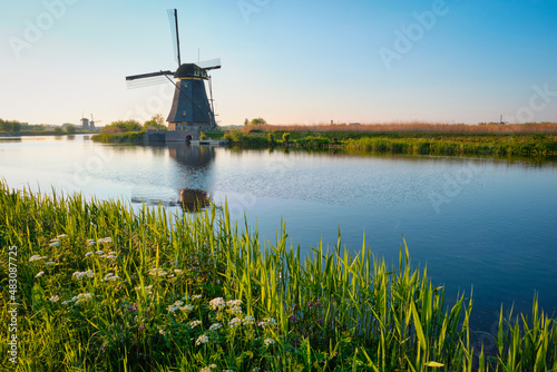 Netherlands rural lanscape with windmills at famous tourist site Kinderdijk in Holland on sunset with dramatic sky