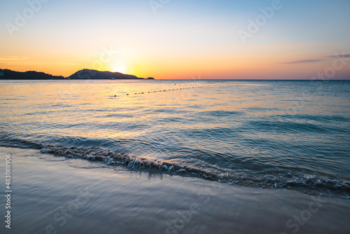 Patong Beach sunset in Phuket Island, the most popular beach in the resort town of Phuket island, Thailand.  Patong beach landscape for vacation, holiday, travel  photo