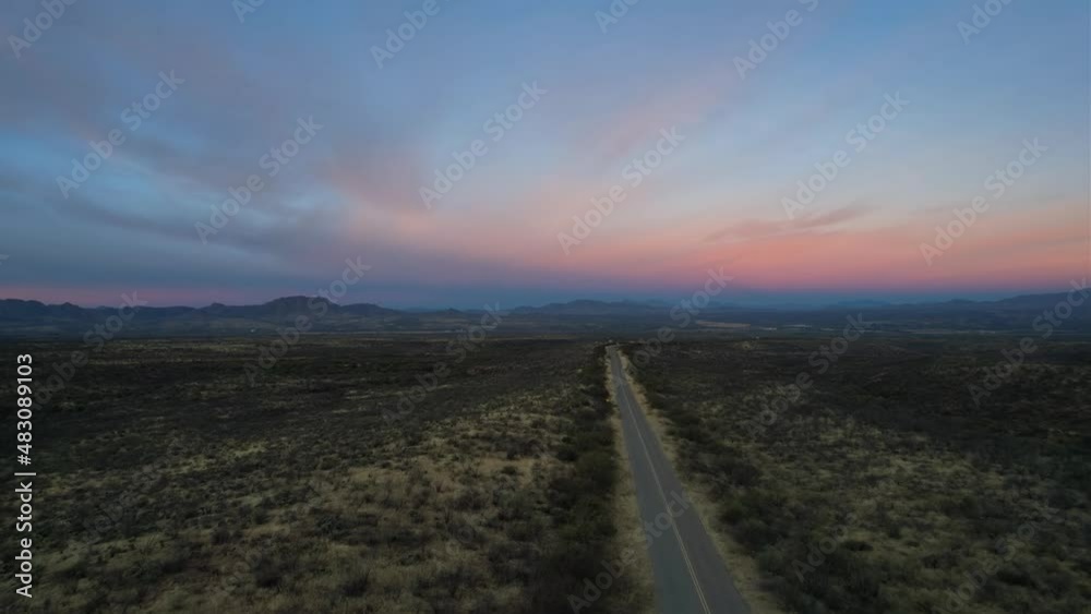 Aerial of an empty highway going through the desert at dawn Aerial of an empty highway going through the desert at dawn