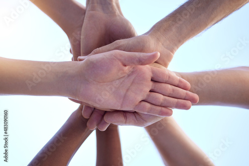 Motivating and building each other up. Shot of a group of people with their hands stacked together.