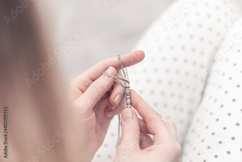 home knitting. girl knits with woolen threads.