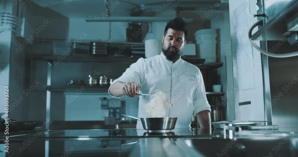 Chef takes ingredient out of pot Chef takes ingredient out of pot