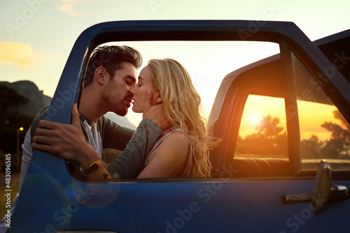 His kisses linger on her lips. Shot of an affectionate young couple on a roadtrip.