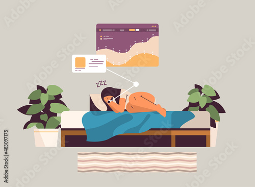woman sleeping in bed with electronic smart watch app tracker on hand quality and quantity sleep control