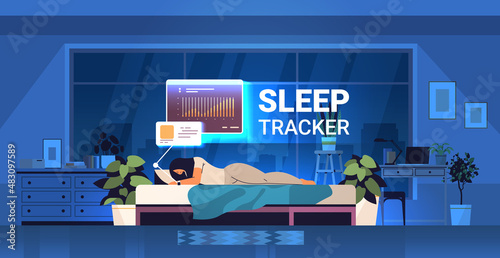 young woman sleeping in bed with electronic smart watch app tracker on hand quality and quantity sleep control