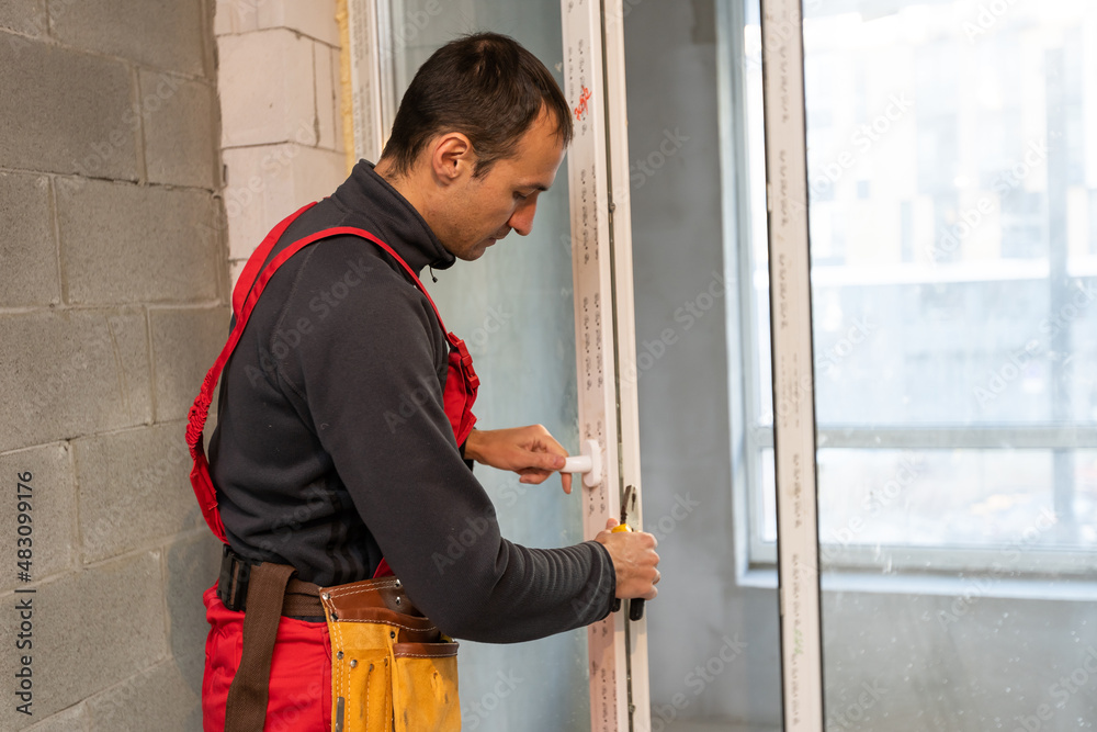 Construction worker repairing windows in house. Construction worker repairing windows in house.