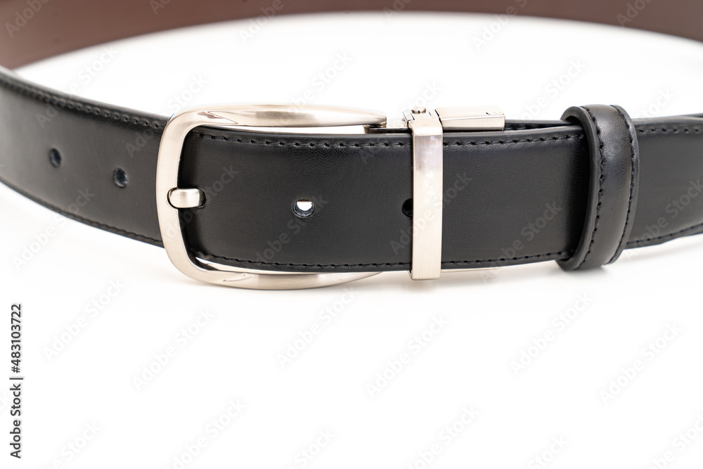 part of Double-sided black and brown leather belt on a white background. part of Double-sided black and brown leather belt on a white background.