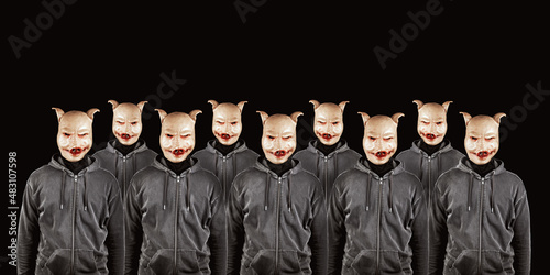 Group of anonymous persons wearing pig masks. Mysterious criminal,social media haters, internet activities concept. Copy space. Black background.
